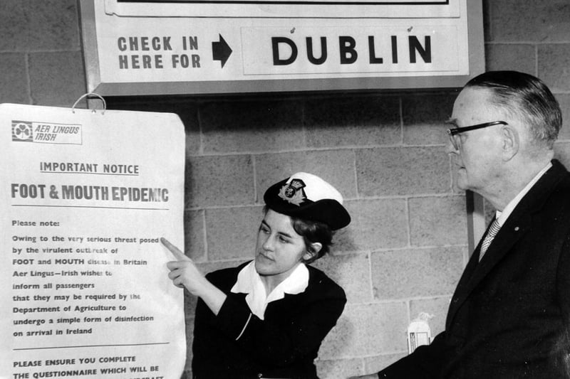 Foot-and-mouth precautions at Leeds and Bradford Airport. Ground hostess Joan Kendall is seen with one of the warning notices.