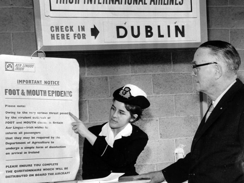 Foot-and-mouth precautions at Leeds and Bradford Airport. Ground hostess Joan Kendall is seen with one of the warning notices.