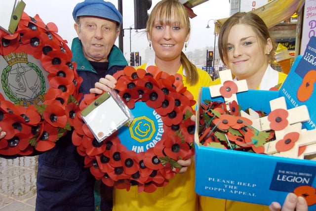Ross Tyson pictured with Harbour Bar staff Helen Corbett and Hayley Botham and some of the wreaths that were to be laid on Remembrance Day in 2005.