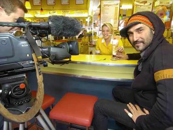 Iranian Tv presenter Behzad Bolour enjoys an ice cream in the Harbour Bar with cameraman Rory Marshall and staff member Charlotte Davis, in 2008.
