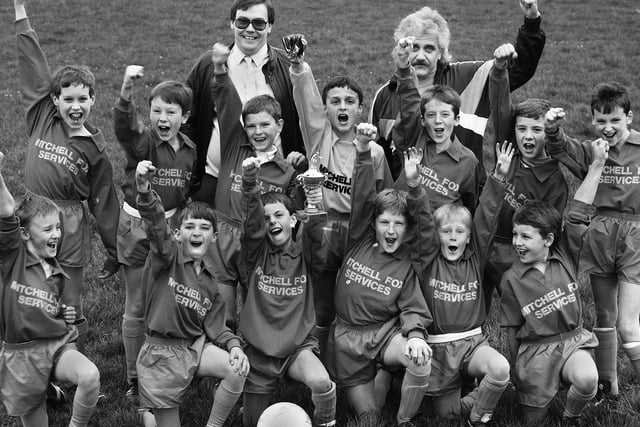 The 19th Wigan Boys Brigade, Vale Methodists, Appley Bridge, celebrate winning the Wigan Section Football Cup Final, beating the 12th Wigan St. John's, Hindley Green, 11-2 at Ince April 1989.  At the back are Gary Fox, left, Director of Mitchell Fox Services, who provided the team strip and team manager Bill Farrell.