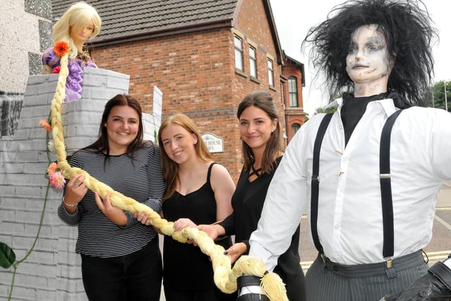 Rapunzal lets down her hair outside Crimpers with staff, from left, Anna Bancroft, Megan Ayres and Ashleigh Clack
