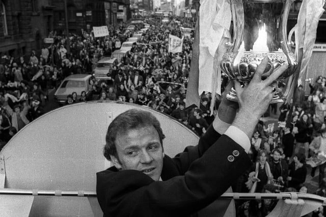 Leeds United captain Billy Bremner with the trophy on the parade bus.