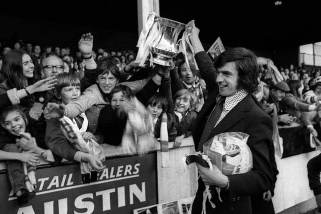 Peter Lorimer parades the trophy. Anyone know why he has a football in a plastic bag?