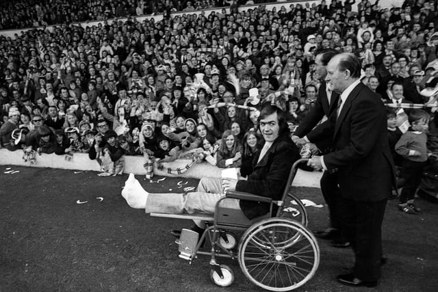 Terry Cooper - who missed the final with a broken leg - is wheeled around Elland Road.