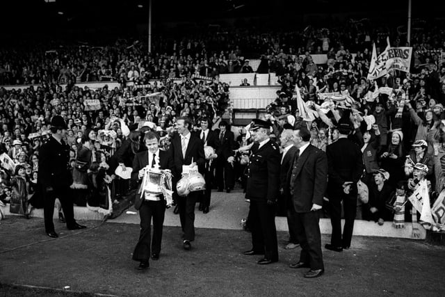 Billy Bremner leads the players out onto the Elland Road pitch to a hero's reception.