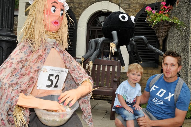 Two-year-old Stanley Elliot and his dad Robert with Miss Muffet and a giant spider at the Garstang Scarecrow Festival