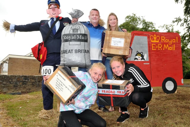 Rear, Dean and Helen Thornley and, front, Ecla Rowes and Lacey Simpson help Postman Pat