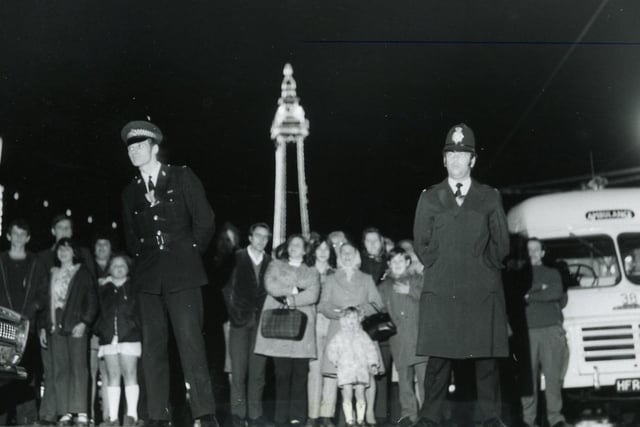 Police control the spectators as fire destroys the Dixieland Bar on Central Pier, September 1973