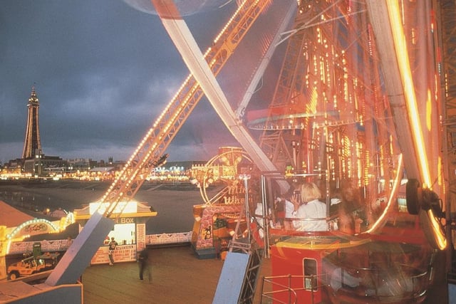 The dazzling lights of the rides and amusements on Central Pier with the Golden Mile in the distance