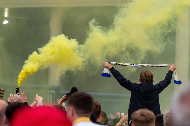 Blue and yellow flares were set off and scarves were held aloft as fans celebrated the promotion.