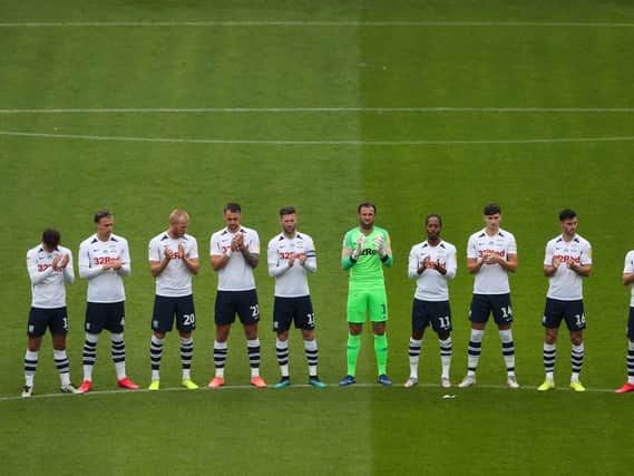 The Preston players applaud the memory of Alex Dawson, the former PNE and Manchester United centre-forward who died on Friday.