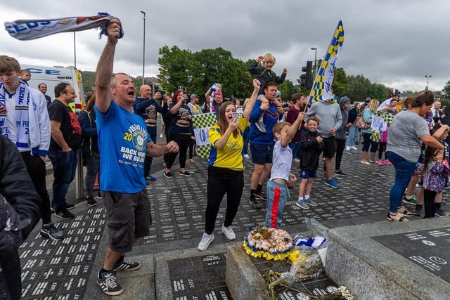 Fans singing songs at the Billy Bremner statue as Leeds were confirmed as champions.