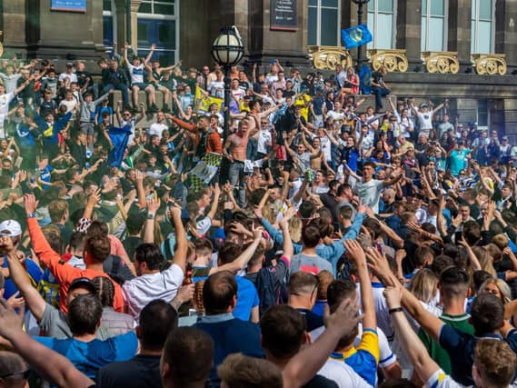 Leeds United fans celebrate at Millennium Square.