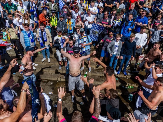 Leeds United fans celebrate at Millennium Square.