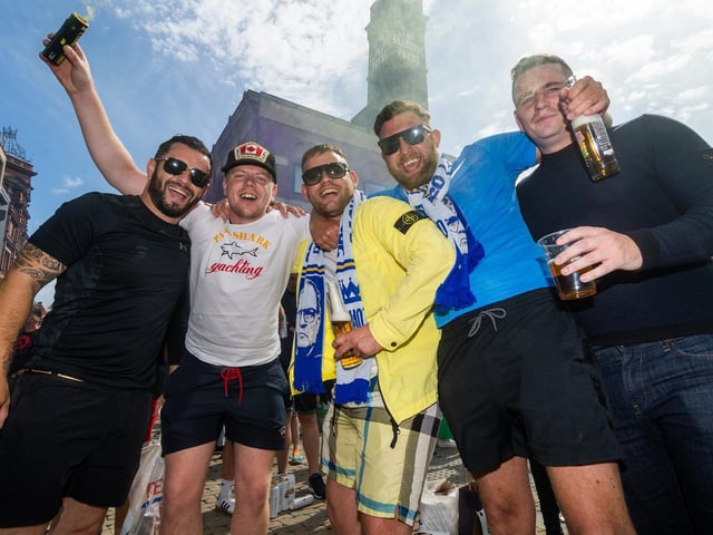Leeds United fans celebrate at Millennium Square.