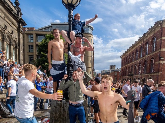 Leeds United fans celebrate at Millennium Square.