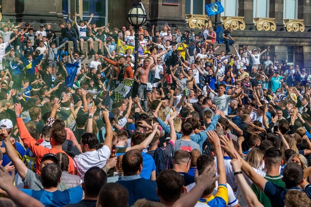 Leeds United fans celebrate at Millennium Square.