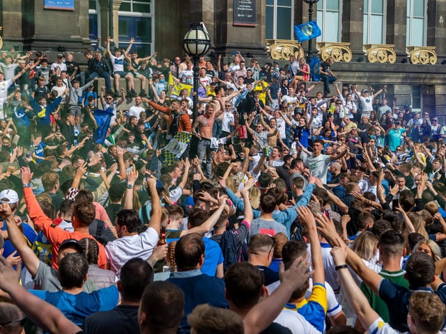 Leeds United fans celebrate at Millennium Square.