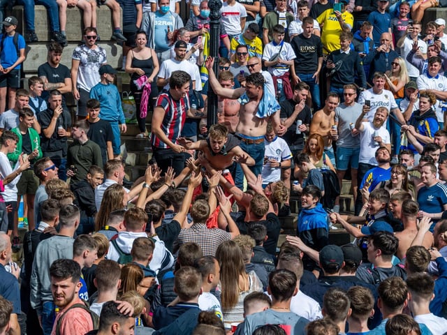 Leeds United fans celebrate at Millennium Square.