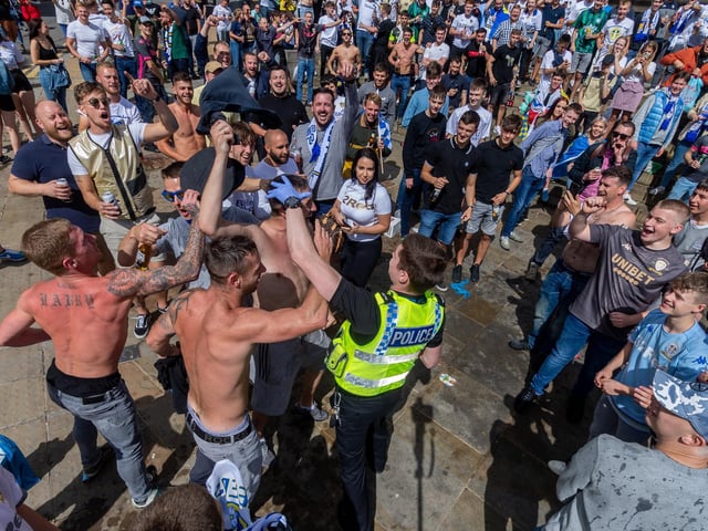 Leeds United fans celebrate at Millennium Square.