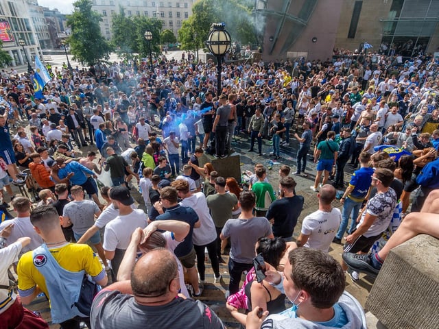 Leeds United fans celebrate at Millennium Square.