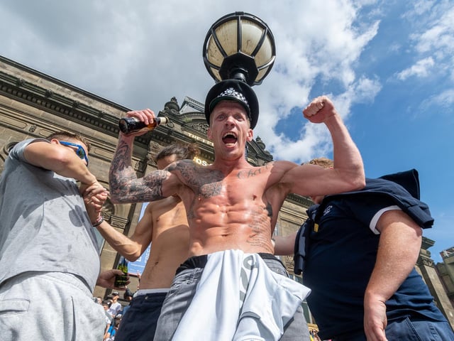 Leeds United fans celebrate at Millennium Square.
