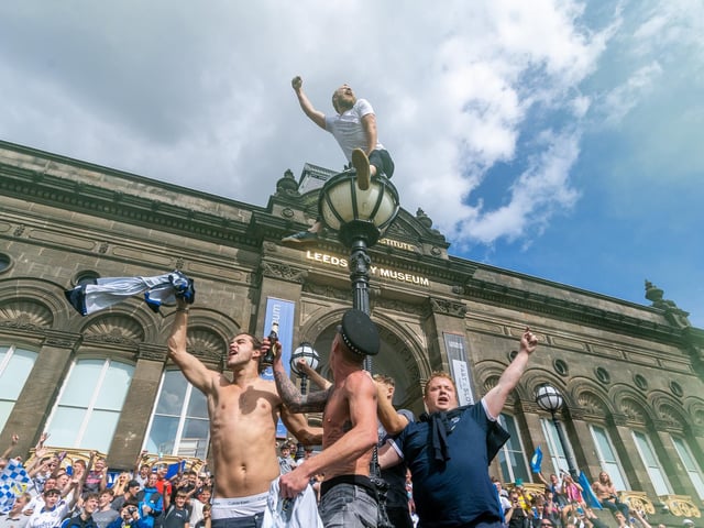 Leeds United fans celebrate at Millennium Square.