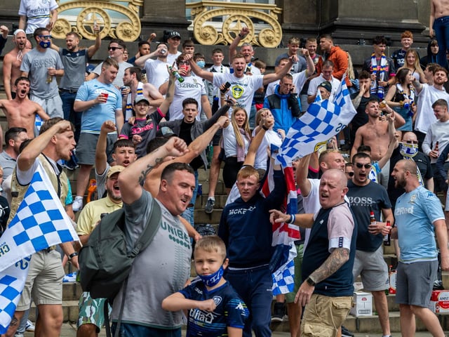 Leeds United fans celebrate at Millennium Square.