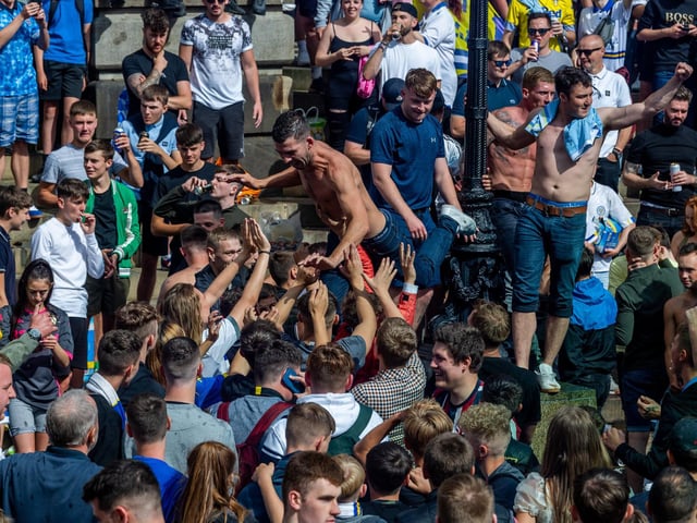 Leeds United fans celebrate at Millennium Square.