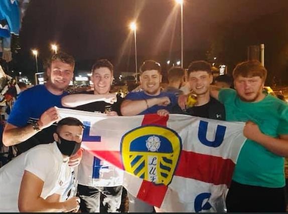 Kaine Tierney celebrating with a Leeds flag with friends