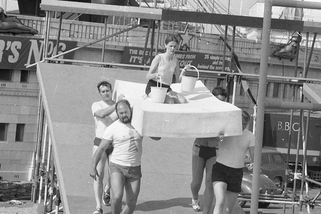Competitors taking part in It's a Knockout at Blackpool's open air baths