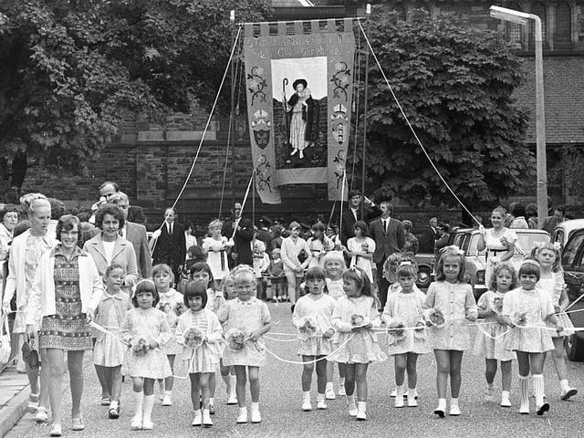 The traditional annual procession of witness by St Ambrose's Church, Farington, although slightly hampered by the weather, made more than the usual spectacle in the village streets. The reason was a newly renovated banner, refurbished by the women of the church and preceded by the tiny tots of the Sunday school pictured here