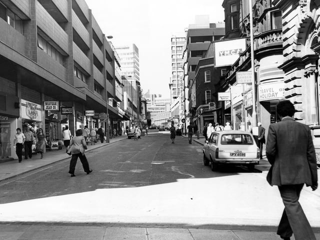 This view of Albion Street is looking up to the Headrow. On the right can be seen a sign for the YMCA, which was above the shops, with the entrance on Albion Place. Number 50 is Hunting Lambert Travel.