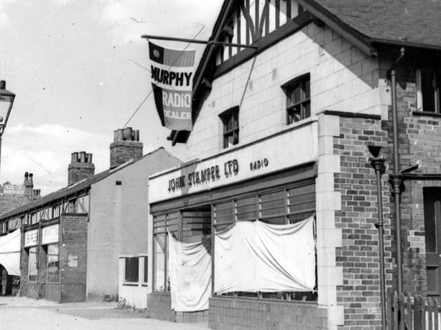J. Stamper Ltd. radio dealer on Station Road in August 1947. Above the shop is a flag pole with flag advertising Murphy radios. The shop windows are draped with sheets.