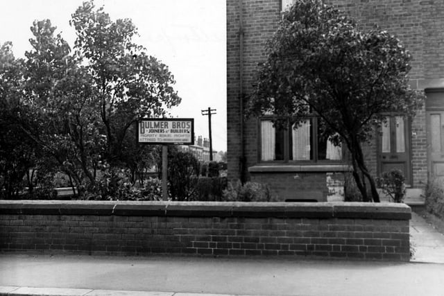 View of the sign and premises of Bulmer Bros. Joiners and builders on Austhorpe Road in July 1948.