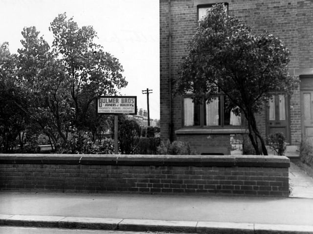 View of the sign and premises of Bulmer Bros. Joiners and builders on Austhorpe Road in July 1948.