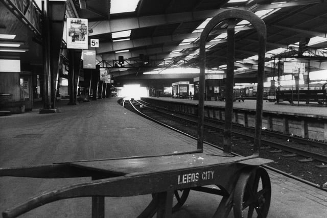 A porter's barrow stands empty on one of the deserted platforms at Leeds City Station, from where only a limited service of local trains were operating owing to the rail strike.