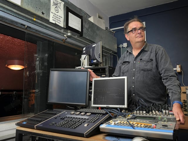 Projectionist Steve Carley checking the film equipment