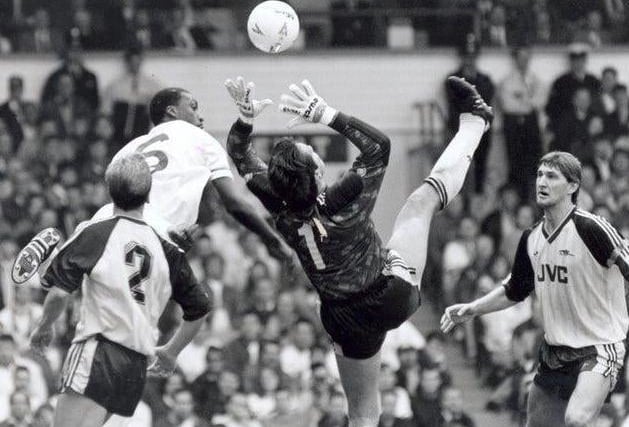 Leeds United battled back from two goals down to draw with the Gunners. David Seaman arches backwards to try and grab the ball away from Chris Whyte as Lee Dixon (left) and Tony Adams look on.