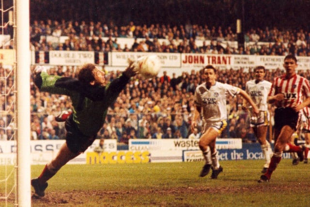 A Gary Speed header beats the outstretched hand of goalkeeper Tony Norman as Lee Chapman looks on.