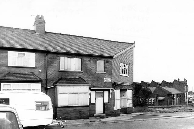 The boarded up premises of South End Grove in May 1979. On the left a caravan is parked while on the right can be seen the J & C.Croysdale Ltd building. South End Grove is located off Stanningley Road.