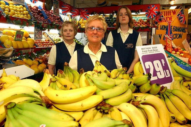 Ellen Young, centre, of Matthew Wade Banana Stall, Preston Market, with collegues Anne Stewart and Rachael Harrison