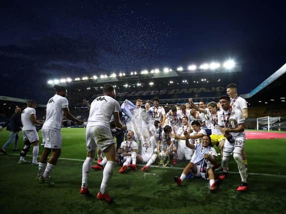 Leeds United players celebrate winning the Championship title. (PA)
