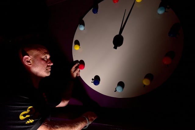 Marcus Rowe of Infiniti Construction checks the clock.

Bespoke items in the hotel on Cliff Bridge Terrace include clocks made of brightly coloured bicycle bells and flip flops