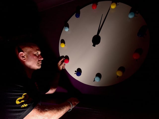 Marcus Rowe of Infiniti Construction checks the clock.
Bespoke items in the hotel on Cliff Bridge Terrace include clocks made of brightly coloured bicycle bells and flip flops