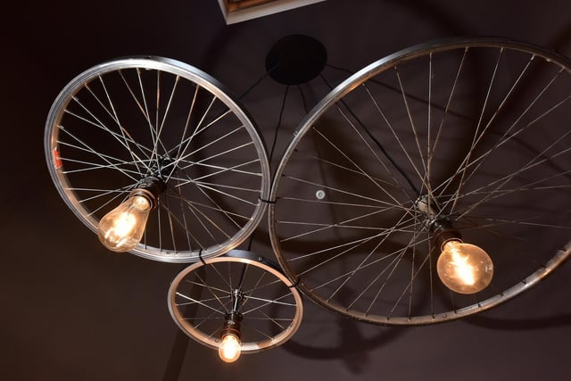 Bespoke lighting was created from old bike wheels and crates, and a bespoke handle for the residents lounge is based on the ampersand between the 'Bike' and 'Boot'.