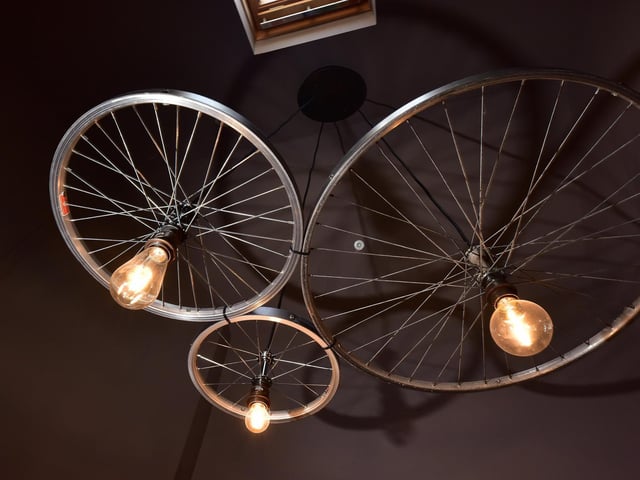 Bespoke lighting was created from old bike wheels and crates, and a bespoke handle for the residents lounge is based on the ampersand between the 'Bike' and 'Boot'.