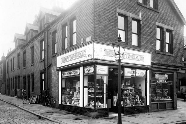 Morris Lane in September 1935. On the left is Station Parade, number 12 is a branch of Thrift Stores, grocers. Customers are offered free insurance and loyalty bonus of 2/6d (twelve and a half pence) for every one pound spent.