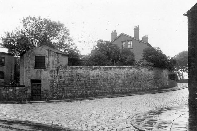 Junction of Church Lane with Morris Lane in August 1934. On the corner is a two storey out building with a stone walled enclosed garden with a house just visible beyond.